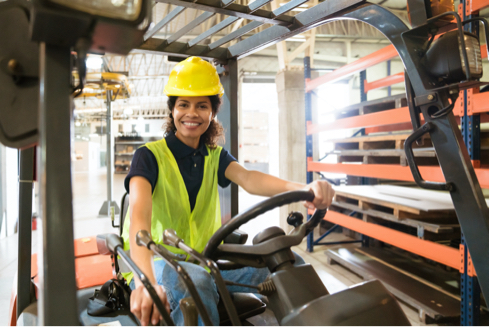 female worker driving a forklift