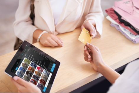 Customer handing credit card to worker for payment 